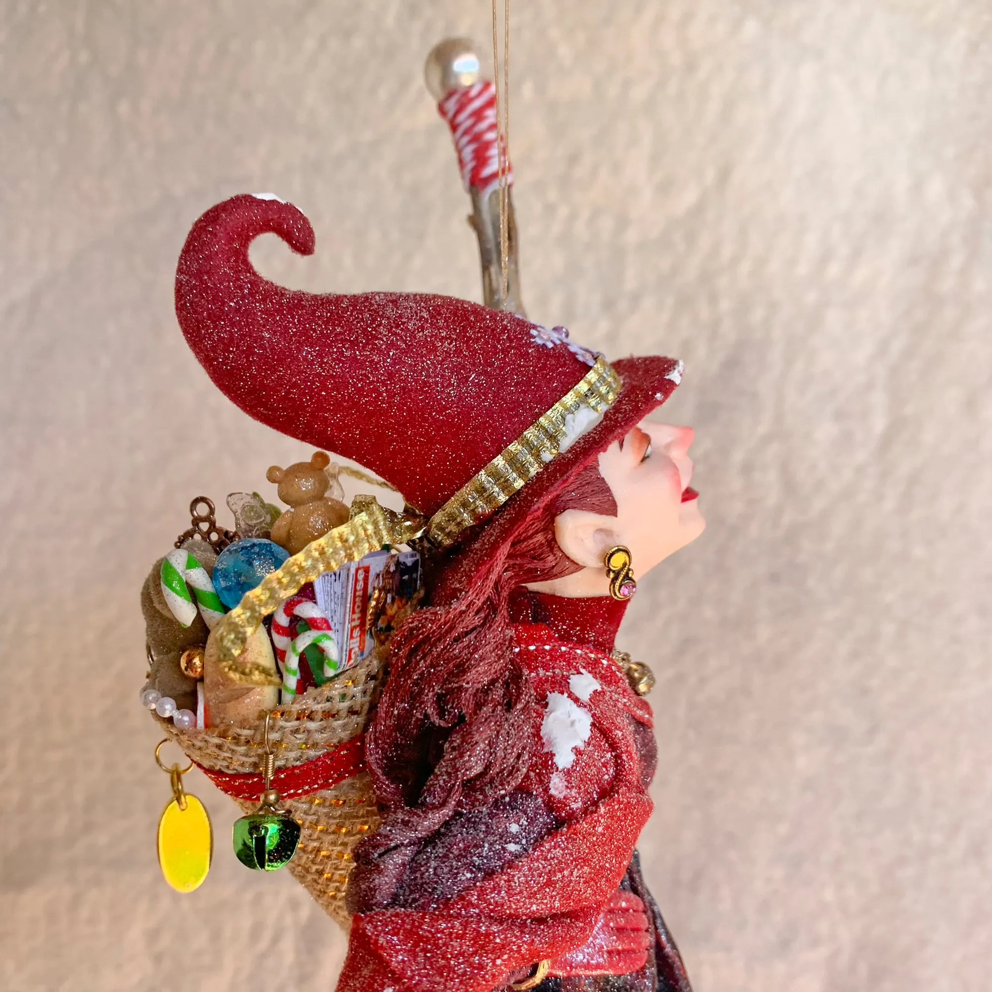 La Bafana - Hovering on her broom Christmas eve waiting to deliver a basket full of Christmas gifts - Hanging Ornament