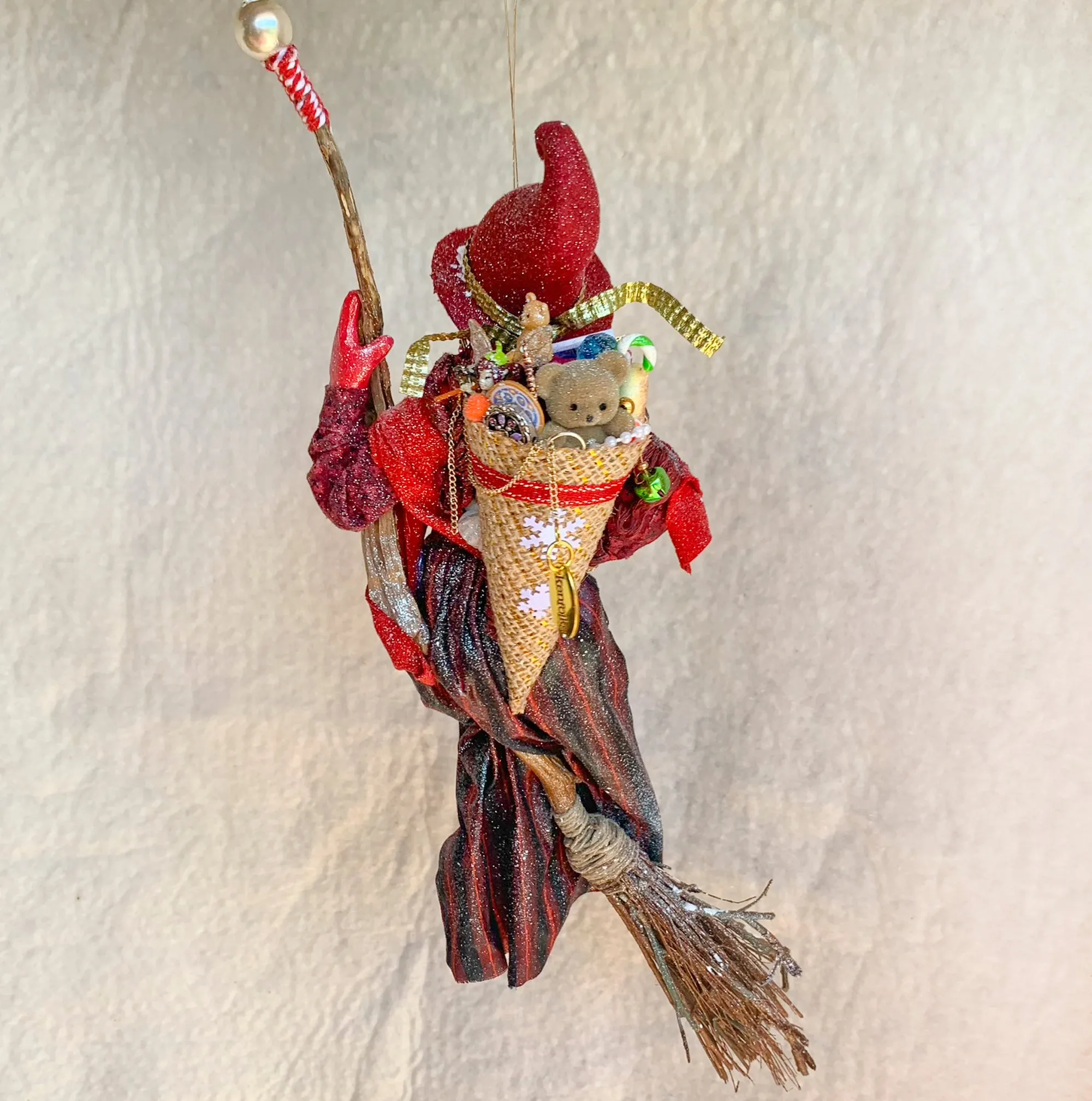 La Bafana - Hovering on her broom Christmas eve waiting to deliver a basket full of Christmas gifts - Hanging Ornament