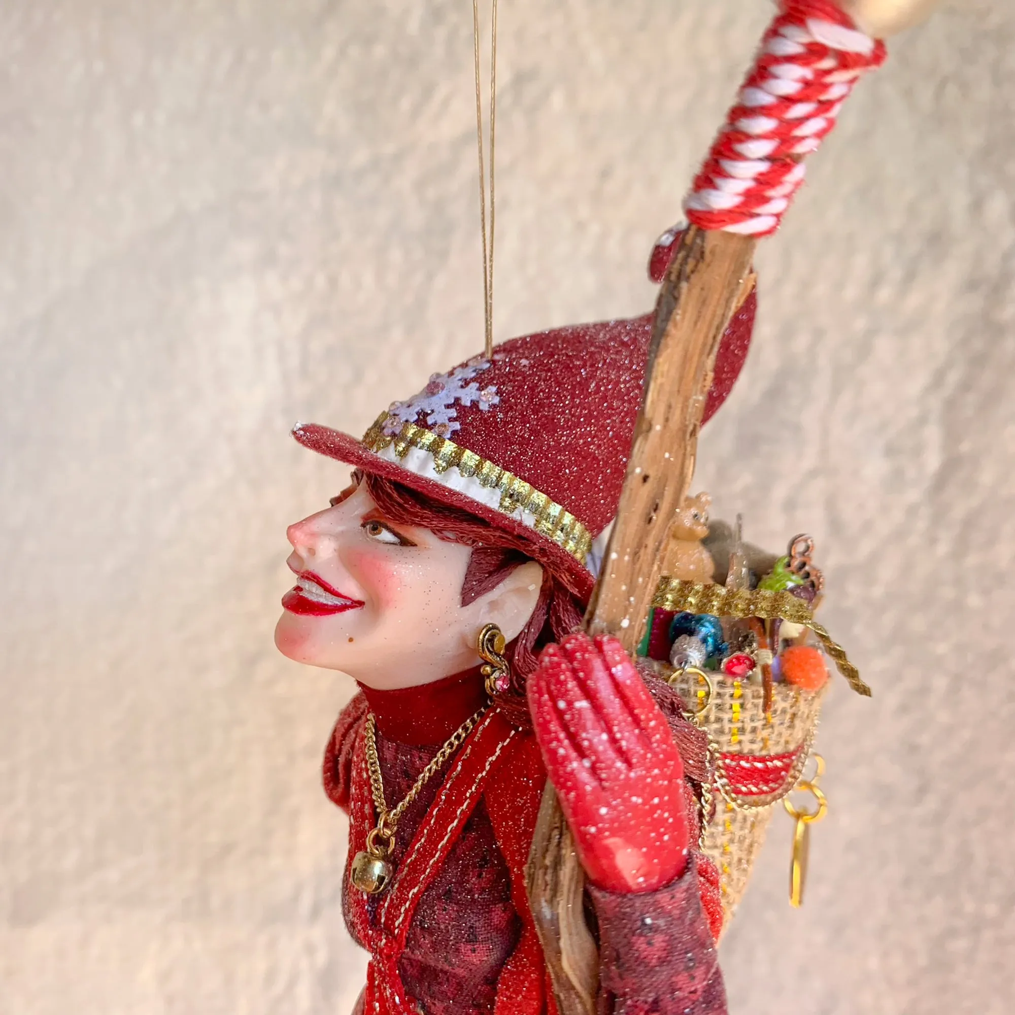 La Bafana - Hovering on her broom Christmas eve waiting to deliver a basket full of Christmas gifts - Hanging Ornament