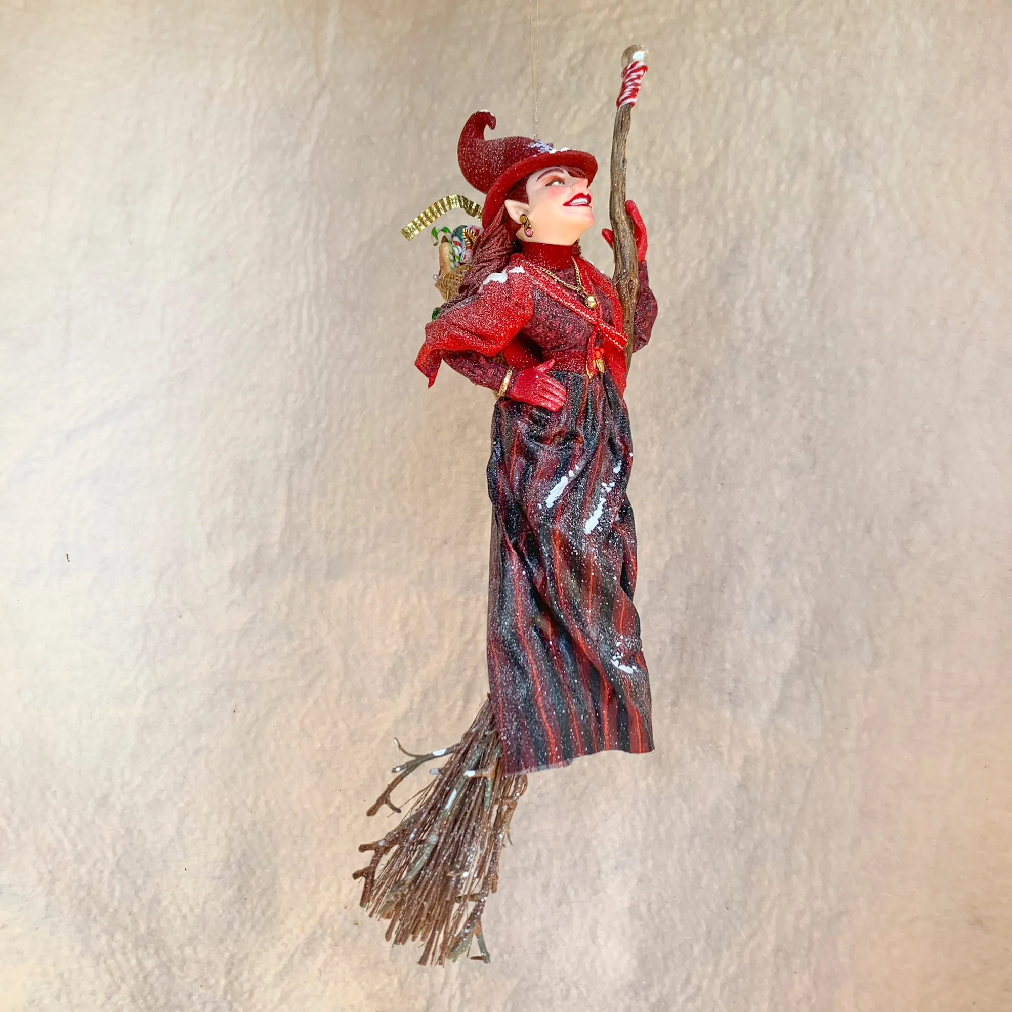 La Bafana - Hovering on her broom Christmas eve waiting to deliver a basket full of Christmas gifts - Hanging Ornament