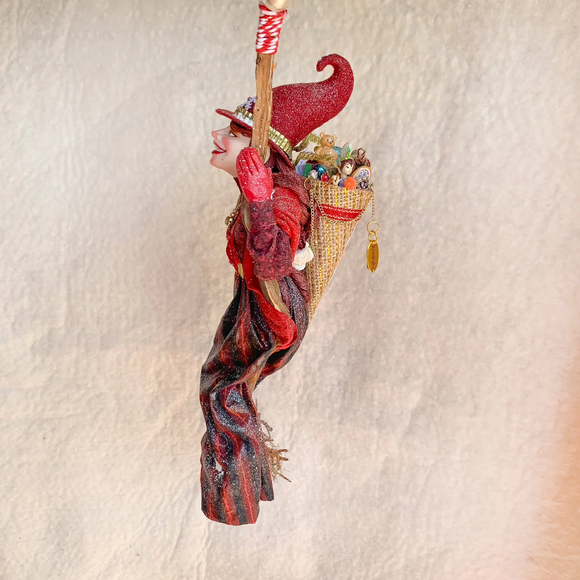 La Bafana - Hovering on her broom Christmas eve waiting to deliver a basket full of Christmas gifts - Hanging Ornament