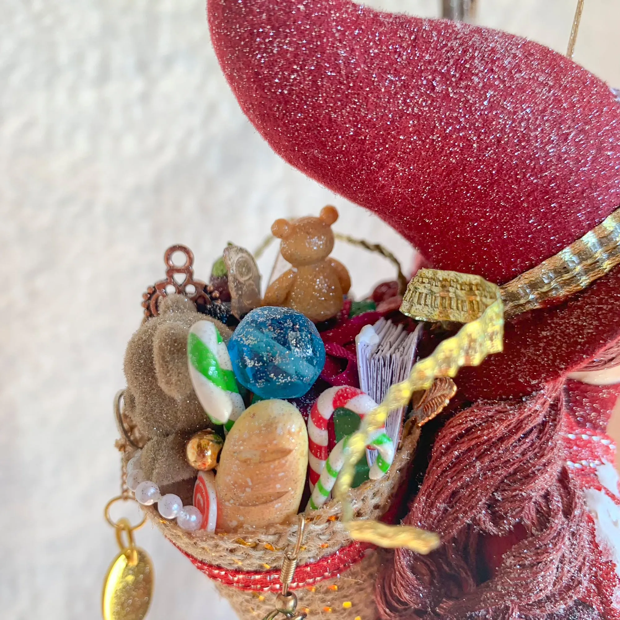 La Bafana - Hovering on her broom Christmas eve waiting to deliver a basket full of Christmas gifts - Hanging Ornament